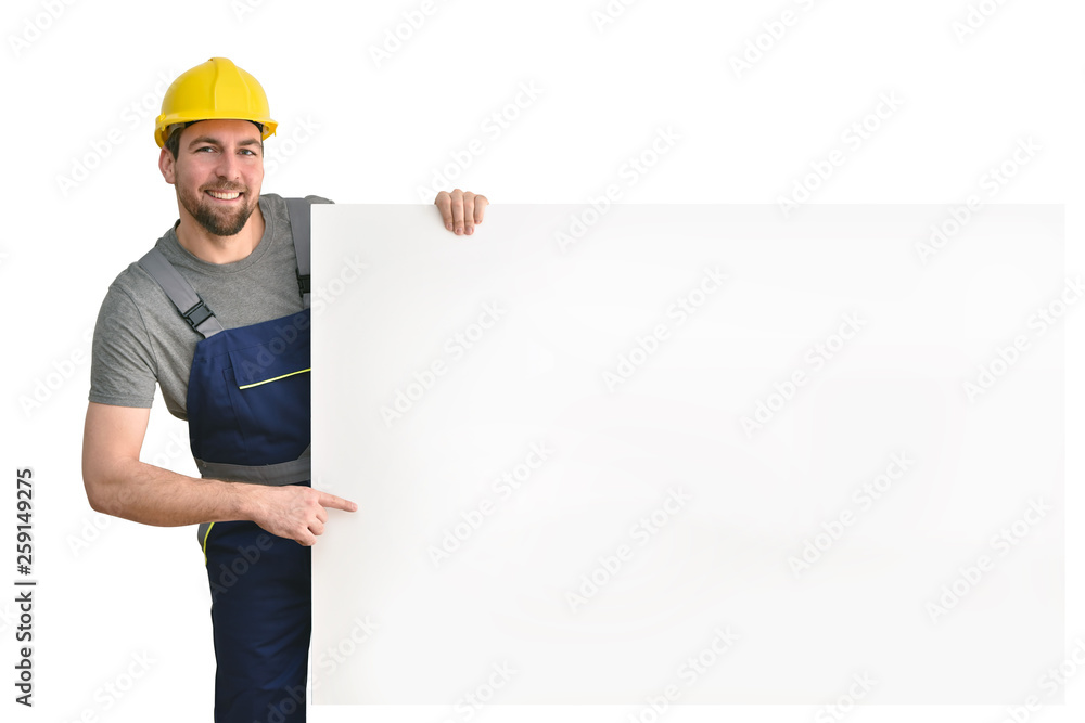 friendly craftsman points to a free billboard - isolated worker with work clothes friendly craftsman points to a free billboard - isolated worker with work clothes