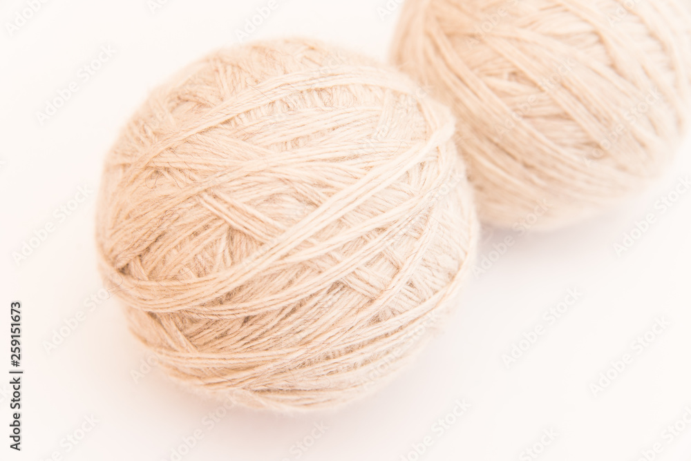 a ball of beige or white wool for knitting and hobbies on a white background a ball of beige or white wool for knitting and hobbies on a white background