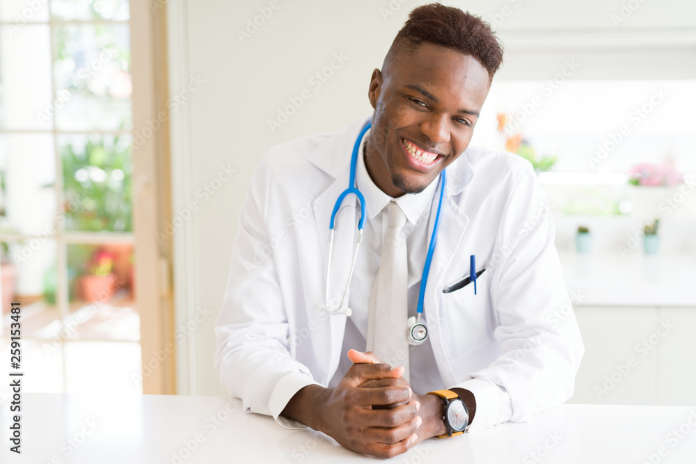 Young african american doctor smiling to the camera wearing stethoscope at the clinic Young african american doctor smiling to the camera wearing stethoscope at the clinic
