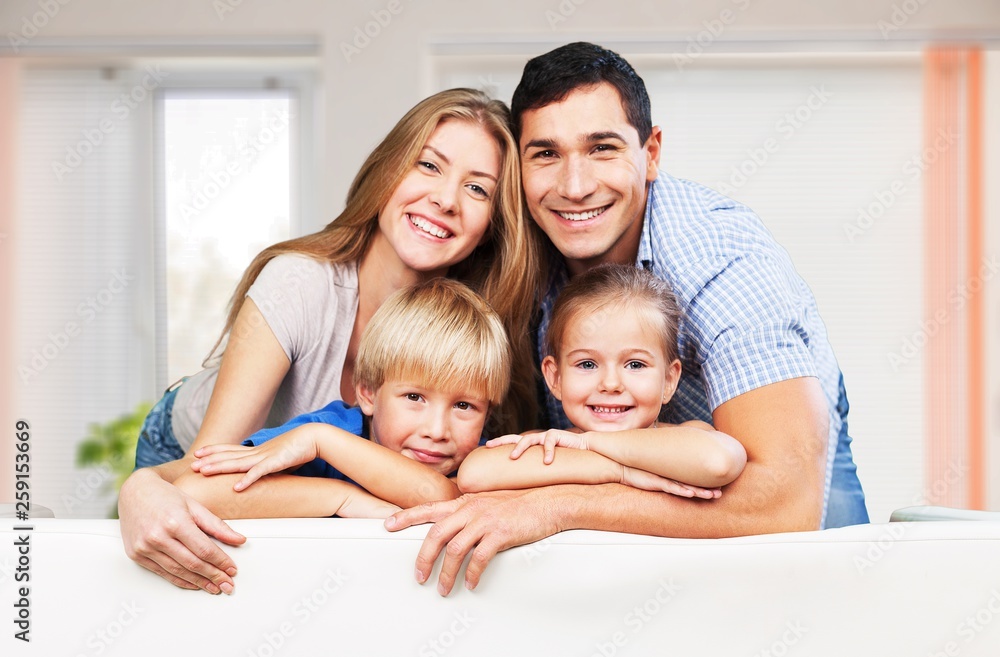 Beautiful smiling family in room on couch