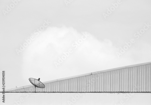 Fototapeta Naklejka Na Ścianę i Meble -  black and white satellite dish on the roof