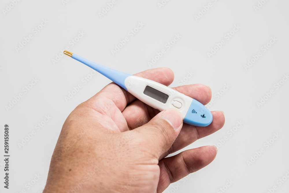 Hand holding the thermometer on white screen isolated Hand holding the thermometer on white screen isolated