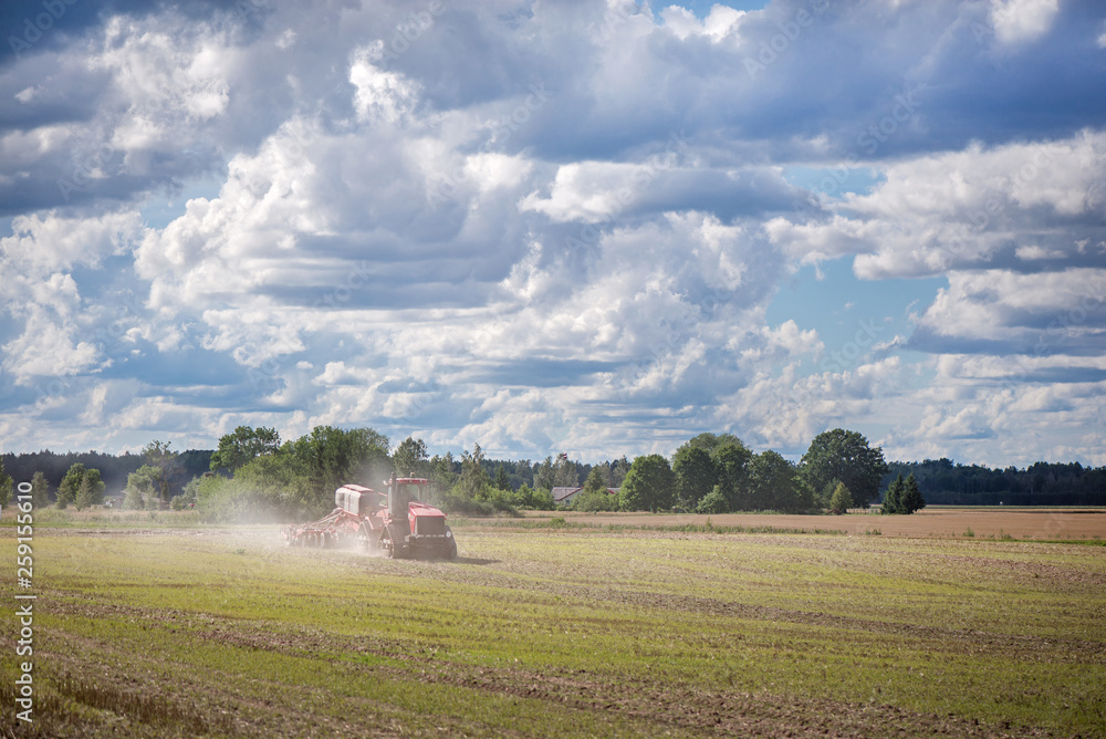 Agricultural background with red tractor pulling plow, throwing dust in air. Combine harvester at wheat field. Heavy machinery during cultivation, working on fields. Dramatic sky, rain, storm clouds
Agricultural background with red tractor pulling plow, throwing dust in air. Combine harvester at wheat field. Heavy machinery during cultivation, working on fields. Dramatic sky, rain, storm clouds