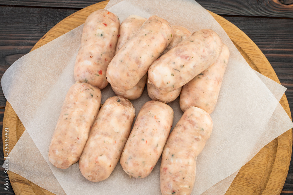 Fresh raw sausage on the wooden background, top view Fresh raw sausage on the wooden background, top view