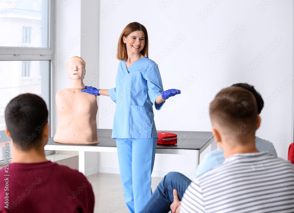 Group of people with instructor at first aid training course Group of people with instructor at first aid training course