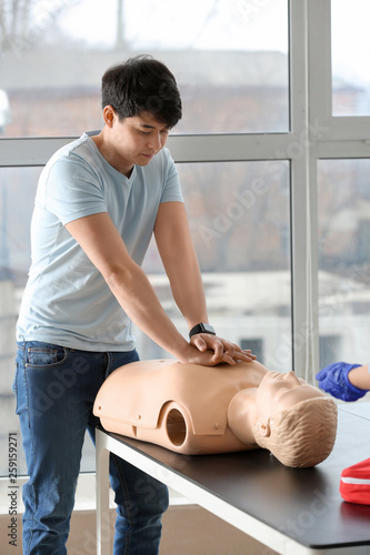 Man learning to perform CPR...