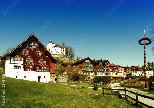 Fototapeta Naklejka Na Ścianę i Meble -  Werdenberg, SG / Switzerland - March 31, 2019: historic Werdenberg village and castle with traditional Burgher homes with wall art and painting