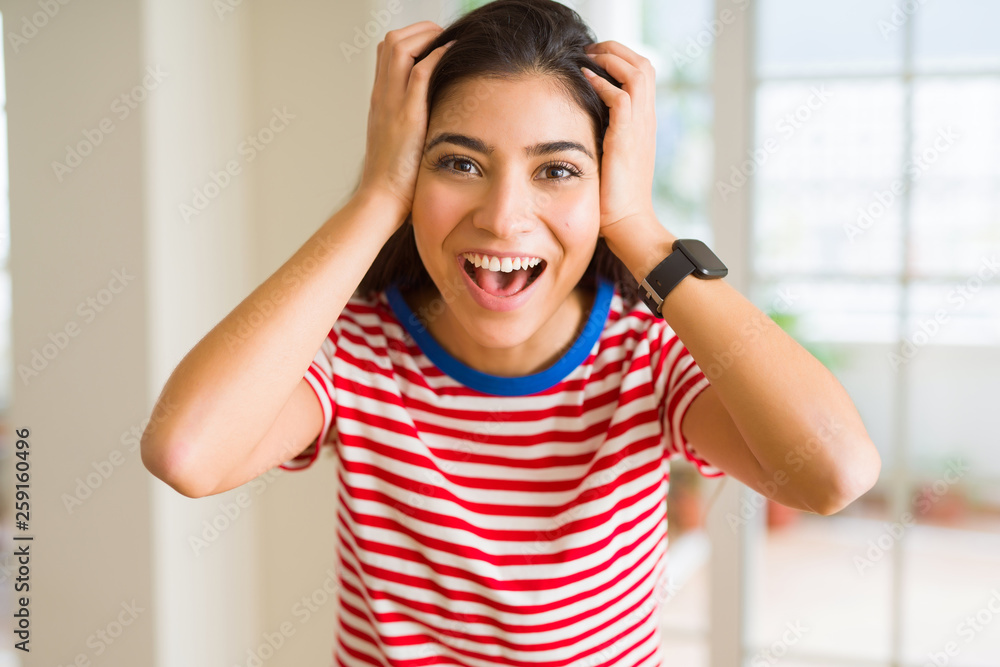 Beautiful young woman celebrating excited for success, screaming and smiling for winning Beautiful young woman celebrating excited for success, screaming and smiling for winning