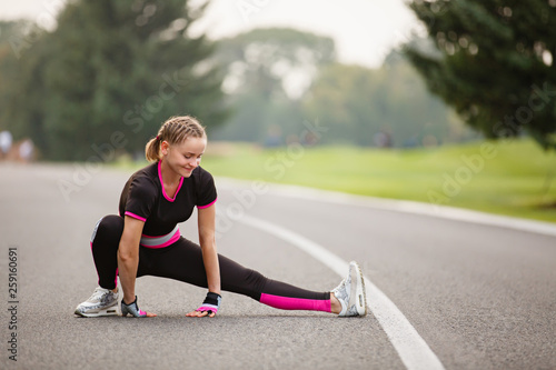 sport girl making exercises outdoors. Young sport woman in a park. Sport and fitness on open air