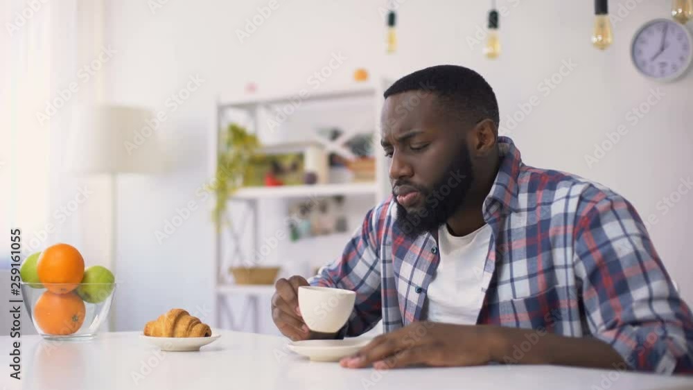 Afro-American man having dental ache, reaction on hot coffee, sensitive teeth Afro-American man having dental ache, reaction on hot coffee, sensitive teeth