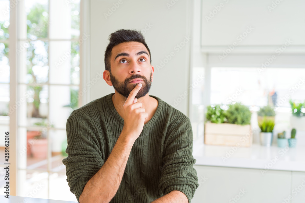 Plakat Handsome man thinking confused about doubt, questioning an idea