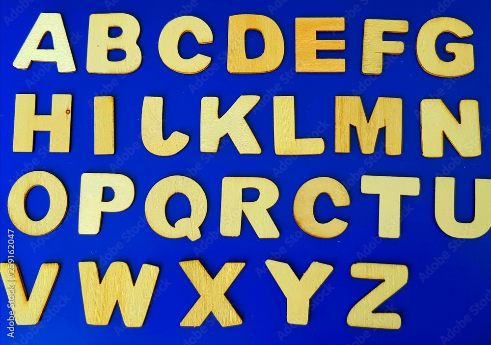wooden letters of the Latin alphabet on a blue background