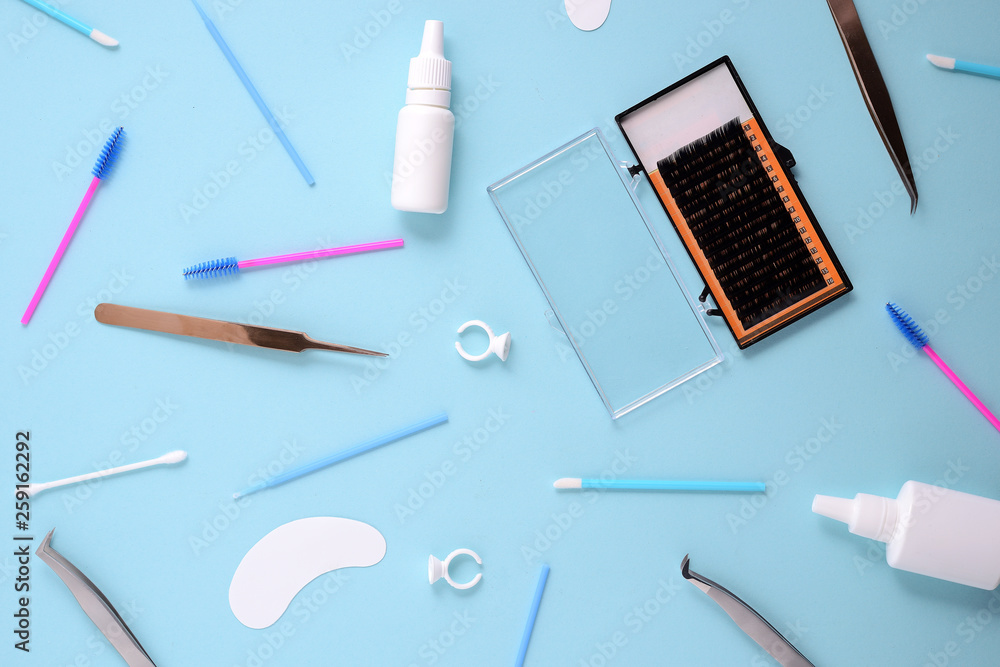 makeup brushes and cosmetics on a blue background. Top view, flat lay makeup brushes and cosmetics on a blue background. Top view, flat lay