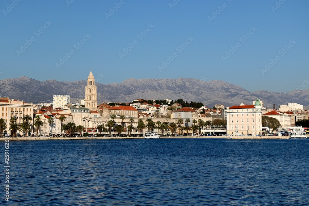 Historical architecture on promenade in Split, Croatia with landmark Saint Domnius tower. Split is popular summer travel destination.