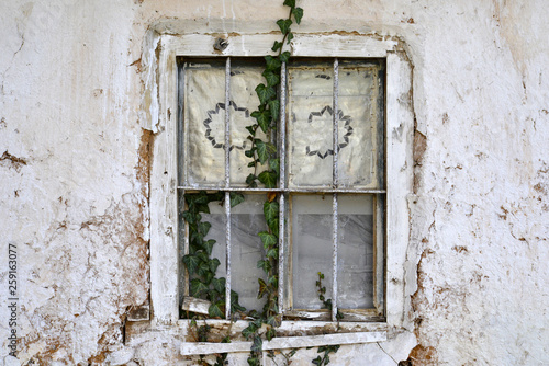 window  of a ruin of an old abandoned building in village of ljubojno in macedonia photo