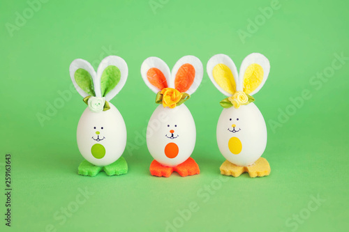 Easter holiday concept with cute handmade funny eggs bunny
