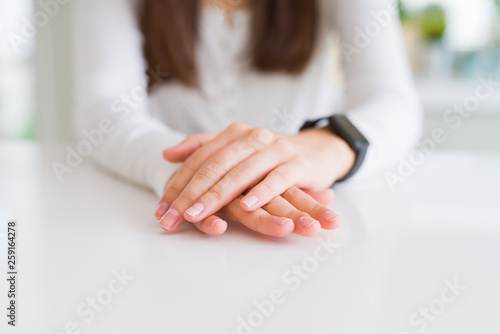 Close up of woman hands over white table