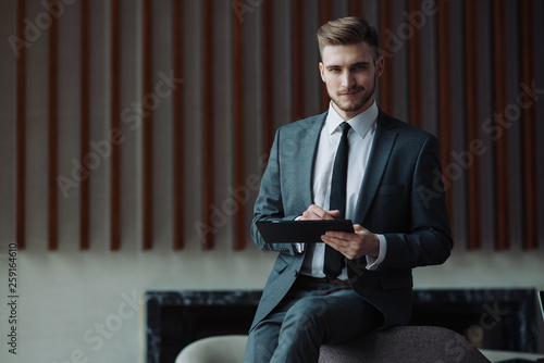 Young businessman working on a plan of Internet project on the laptop. Man discusses business matters by phone. Working computer for internet research. Digital marketing. Development