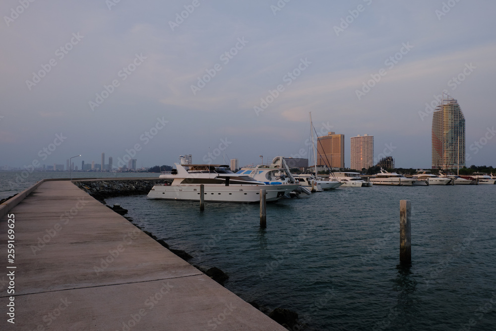 Fototapeta premium View of the sunset city from the pier in Pattaya