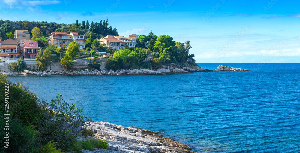 Beautiful summer panoramic seascape.  Green slopes in close bays with crystal clear azure water. Coastline of north part Corfu island, Ionian archipelago, Kassiopi, Greece.