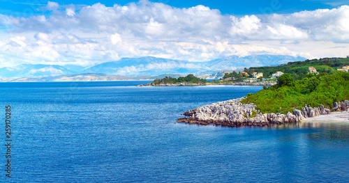 Beautiful summer panoramic seascape. Green slopes in close bays with crystal clear azure water. Coastline of north part Corfu island, Ionian archipelago, Kassiopi, Greece.