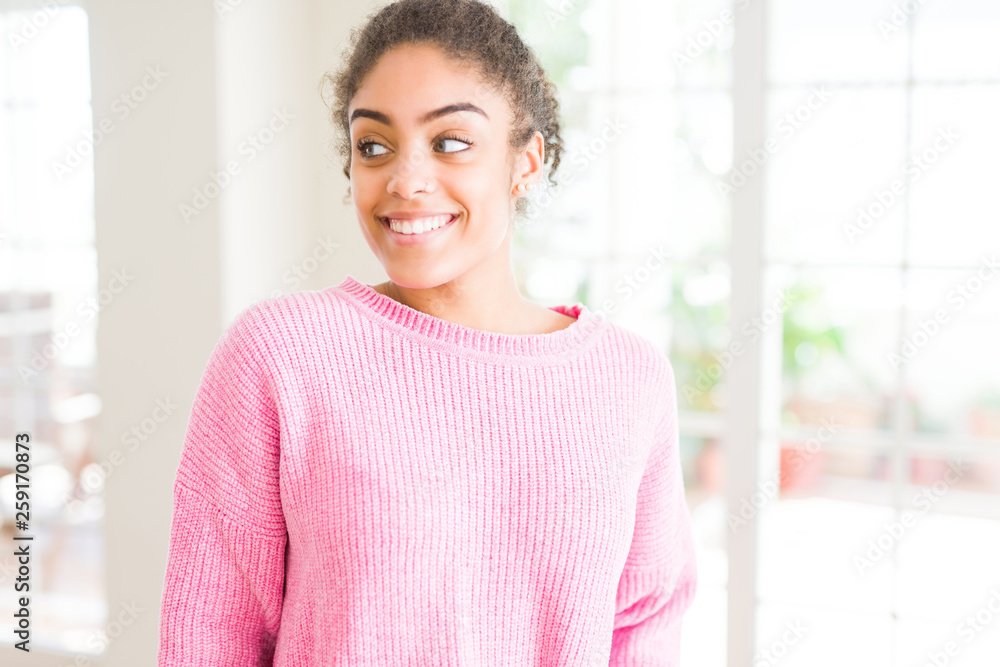 Beautiful young african american woman with afro hair smiling looking side and staring away thinking. Beautiful young african american woman with afro hair smiling looking side and staring away thinking.