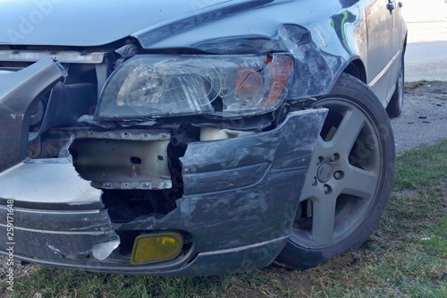 Car accident concept. Car crash  frontal collision  damaged front of blue car  broken light and fender.