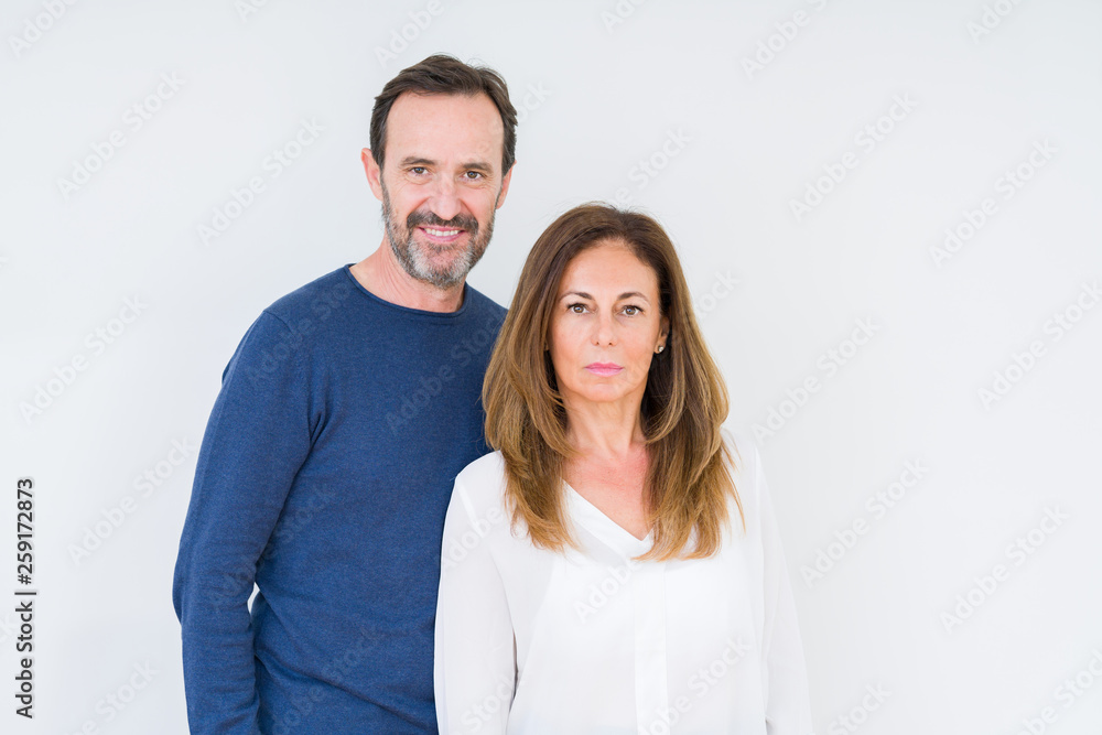 Beautiful middle age couple in love over isolated background Relaxed with serious expression on face. Simple and natural looking at the camera. Beautiful middle age couple in love over isolated background Relaxed with serious expression on face. Simple and natural looking at the camera.