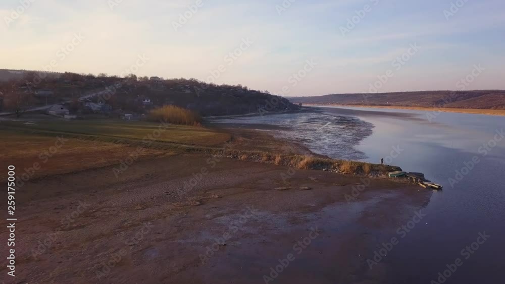 Arial view over the river and small village at sunset. Dniester river of Moldova republic. Arial view over the river and small village at sunset. Dniester river of Moldova republic.