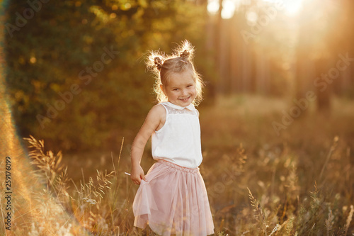 children's portrait of a girl. beautiful girl at sunset