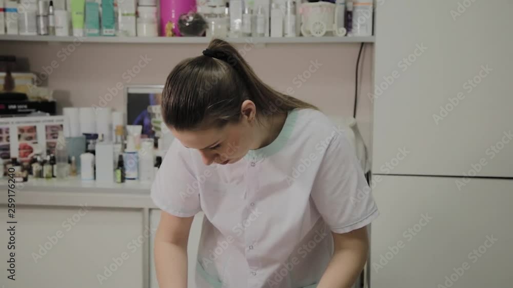 A woman is cleaned with special wipes in the beauty salon. A woman is cleaned with special wipes in the beauty salon.
