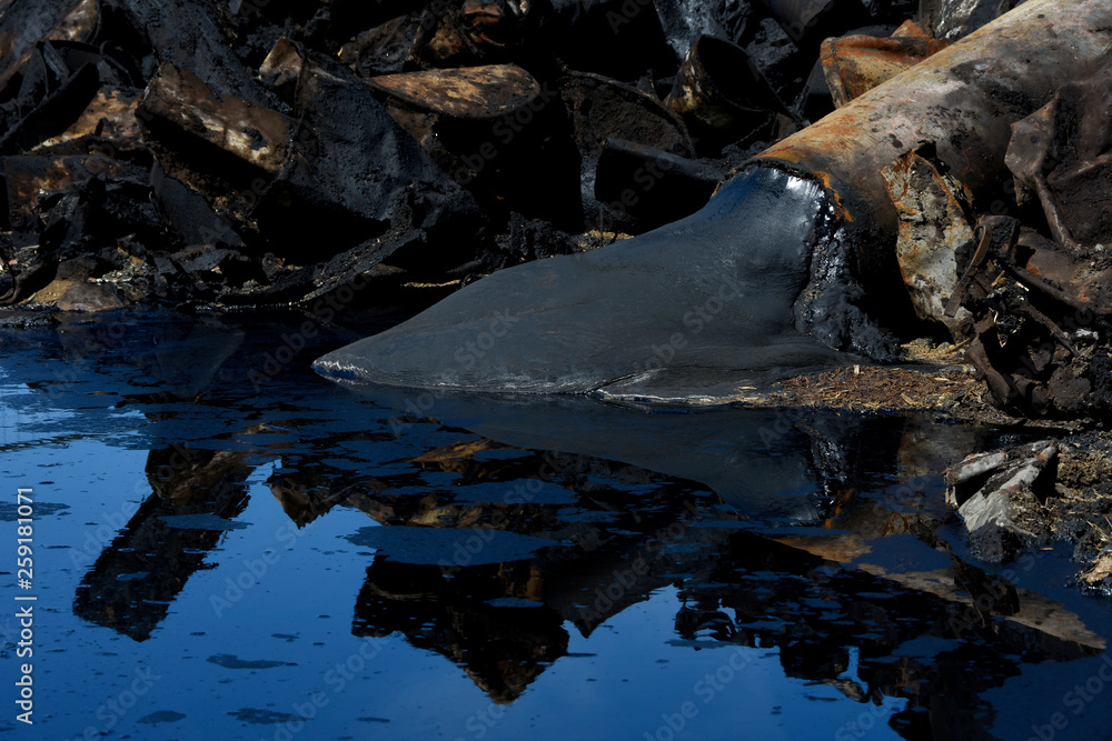 Oil pollution with dirty pipes and barrels