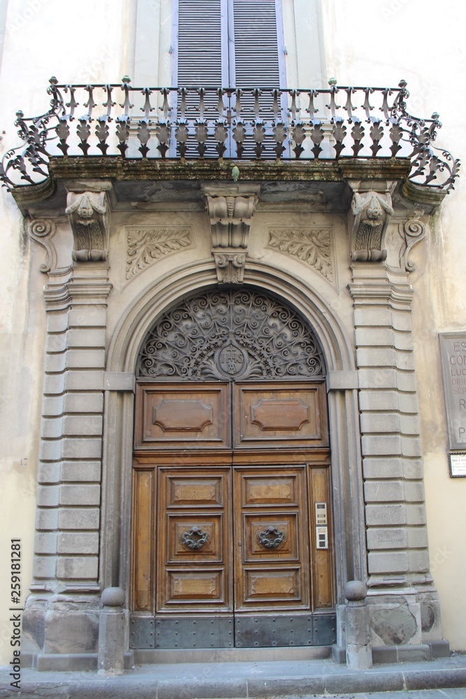 architecturally decorated entrance with a balcony architecturally decorated entrance with a balcony