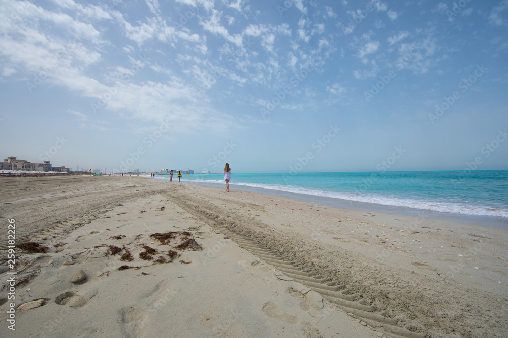 panoramic photo of beach sand, blue sea and blue sky