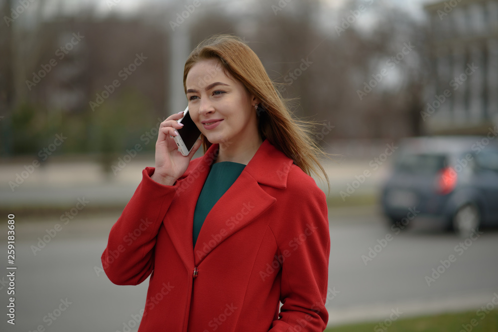Beautiful girl walking and talking on the phone Beautiful girl walking and talking on the phone