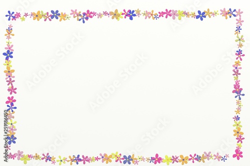 Frame with colorful daisy heads on the white background