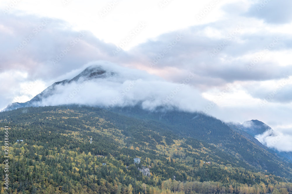 Low hanging clouds touching mountain peaks. Scenic landscape views.