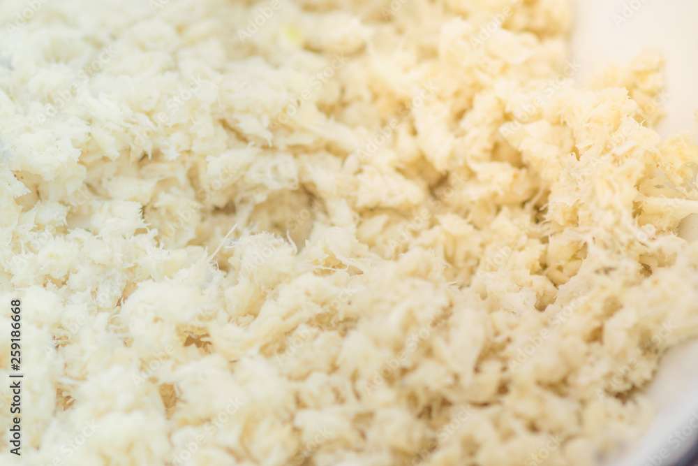 Grated horseradish root background close-up. Macro shot Grated horseradish root background close-up. Macro shot