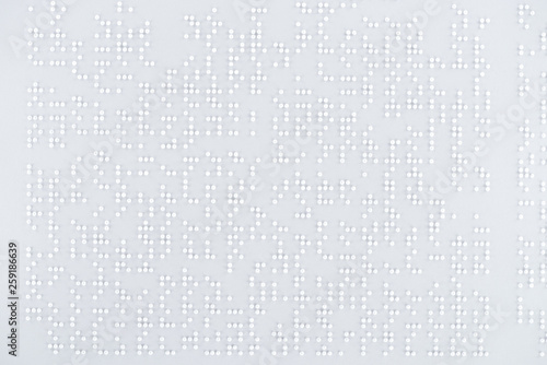 top view of text in international braille code on white paper photo