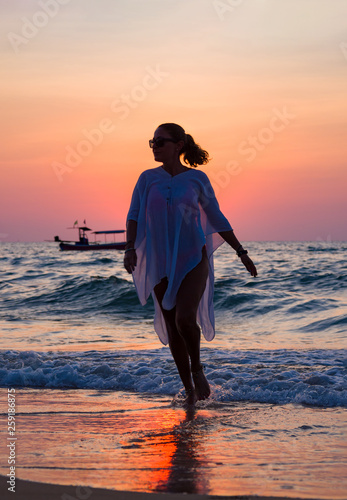 Woman walking on the beach a