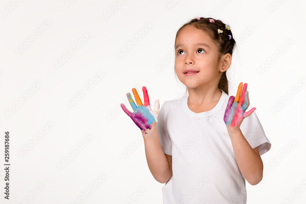 cute little child girl with hands painted in colorful paint isolated on white background. cute little child girl with hands painted in colorful paint isolated on white background.