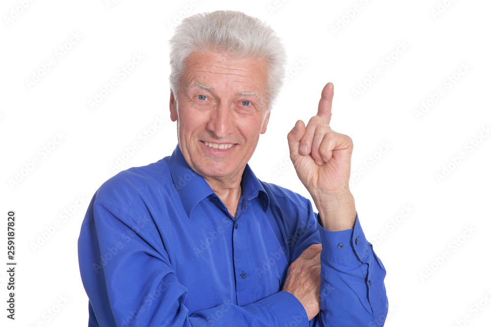 Portrait of senior man pointing upward on white background Portrait of senior man pointing upward on white background