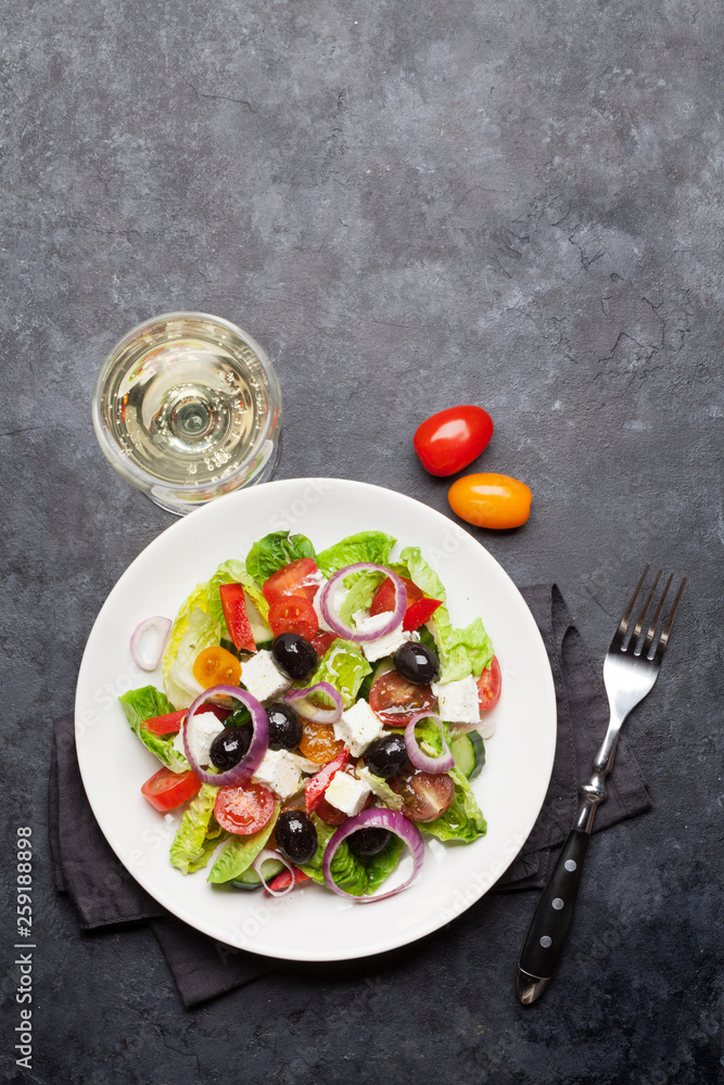 Greek salad plate and white wine Greek salad plate and white wine