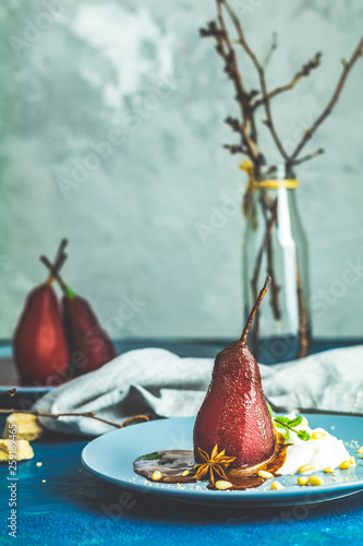 Traditional dessert pears stewed in red wine with chocolate sauce