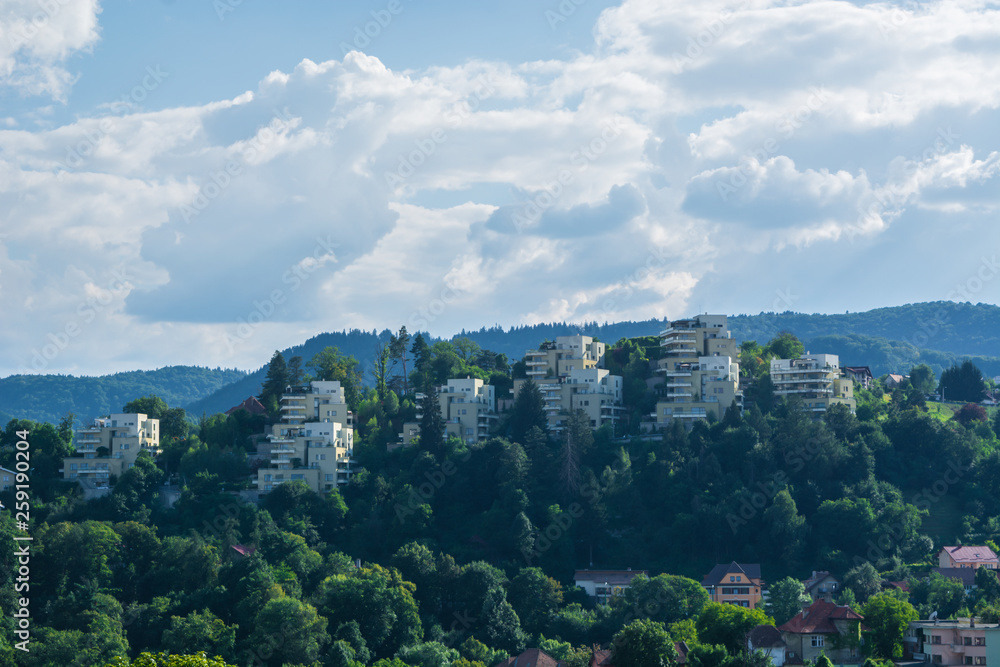 Row of modern residential buildings surrounded by nature and forest in Brasov, Romania, Eastern Europe. Concept of wealth, high standard of living and expensive houses. 