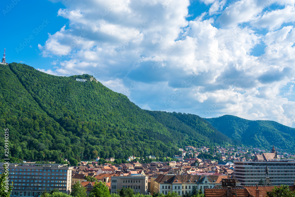 Panorama of the medieval Brasov city with Tampa mountain in the background and the old historic city center in the foreground Transylvania, Romania, Eastern Europe. Famous tourist attraction.