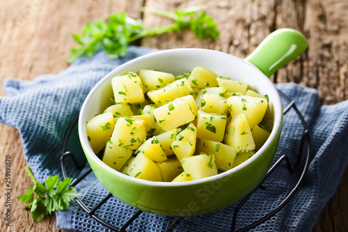 Bilde på lerret Fresh homemade boiled potatoes with parsley in bowl (Selective Focus, Focus in t