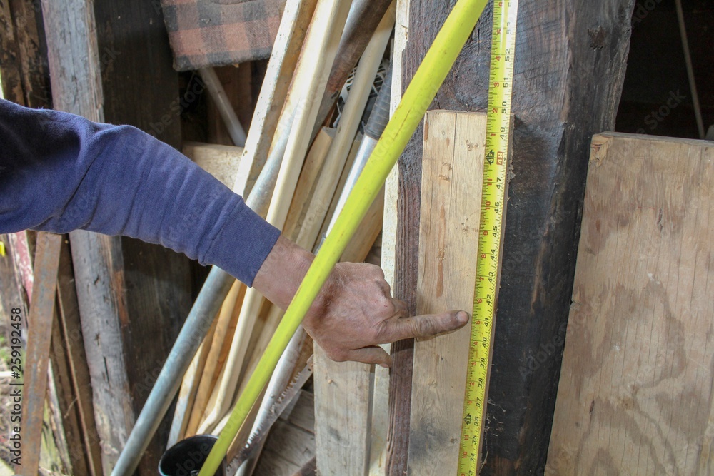 Closeup of Older Man's Hand using measuring tape