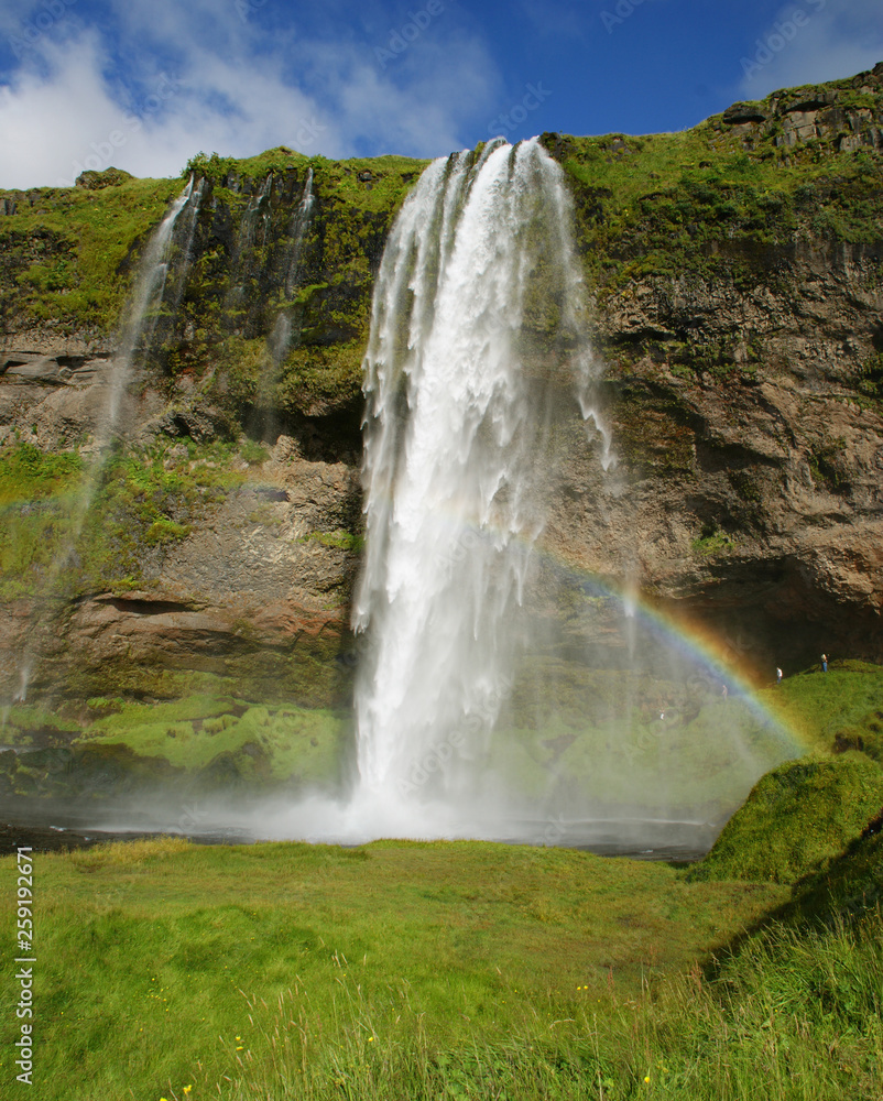 Seljalandsfoss waterfall in the river Seljalands a 60 meters (197 ft) cascade, next to route 1 in the southern Iceland. It is possible to visit it behind side by a small cave