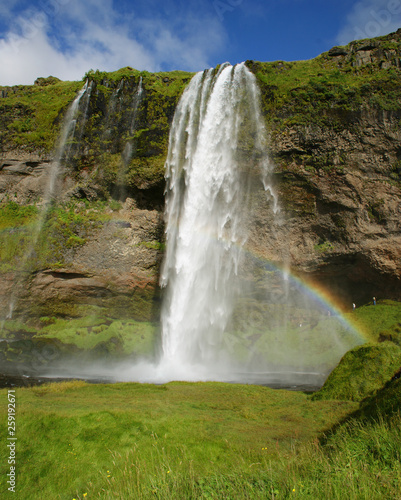 Seljalandsfoss waterfall in the river Seljalands a 60 meters  197 ft  cascade  next to route 1 in the southern Iceland. It is possible to visit it behind side by a small cave